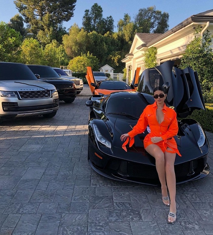 Kylie wearing Versace V Medusa with an orange Christian Cowan dress.